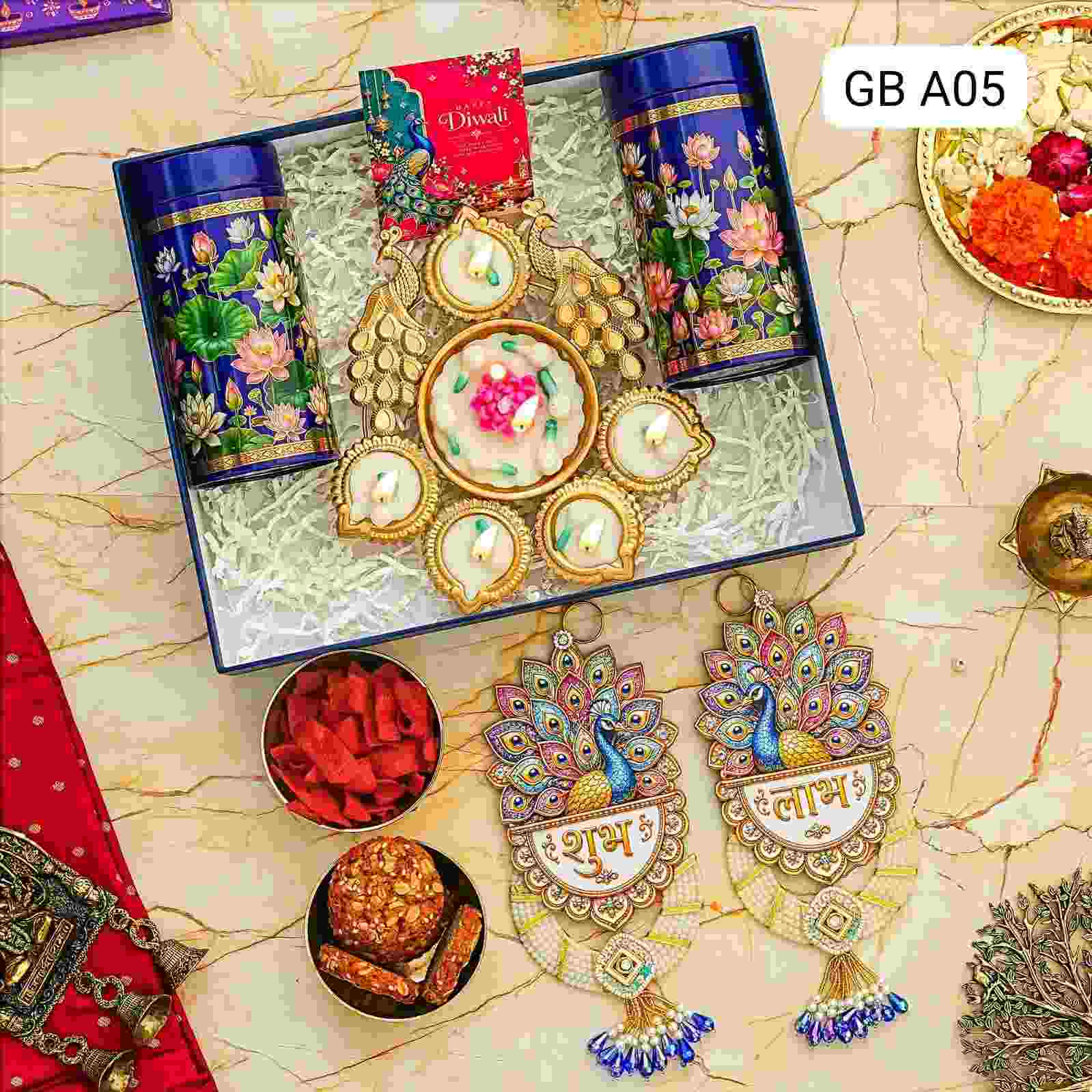 Shubh Labh Royale Hamper | Festive Diwali Gift Box 1 Luxury Shubh Labh Royale Hamper featuring heavy Shubh Labh hangings, 6-inch wax peacock urli, 2 tin jars with gourmet treats, and a Diwali card in a premium box. Shubh Labh Royale Hamper | Festive Diwali Gift Box