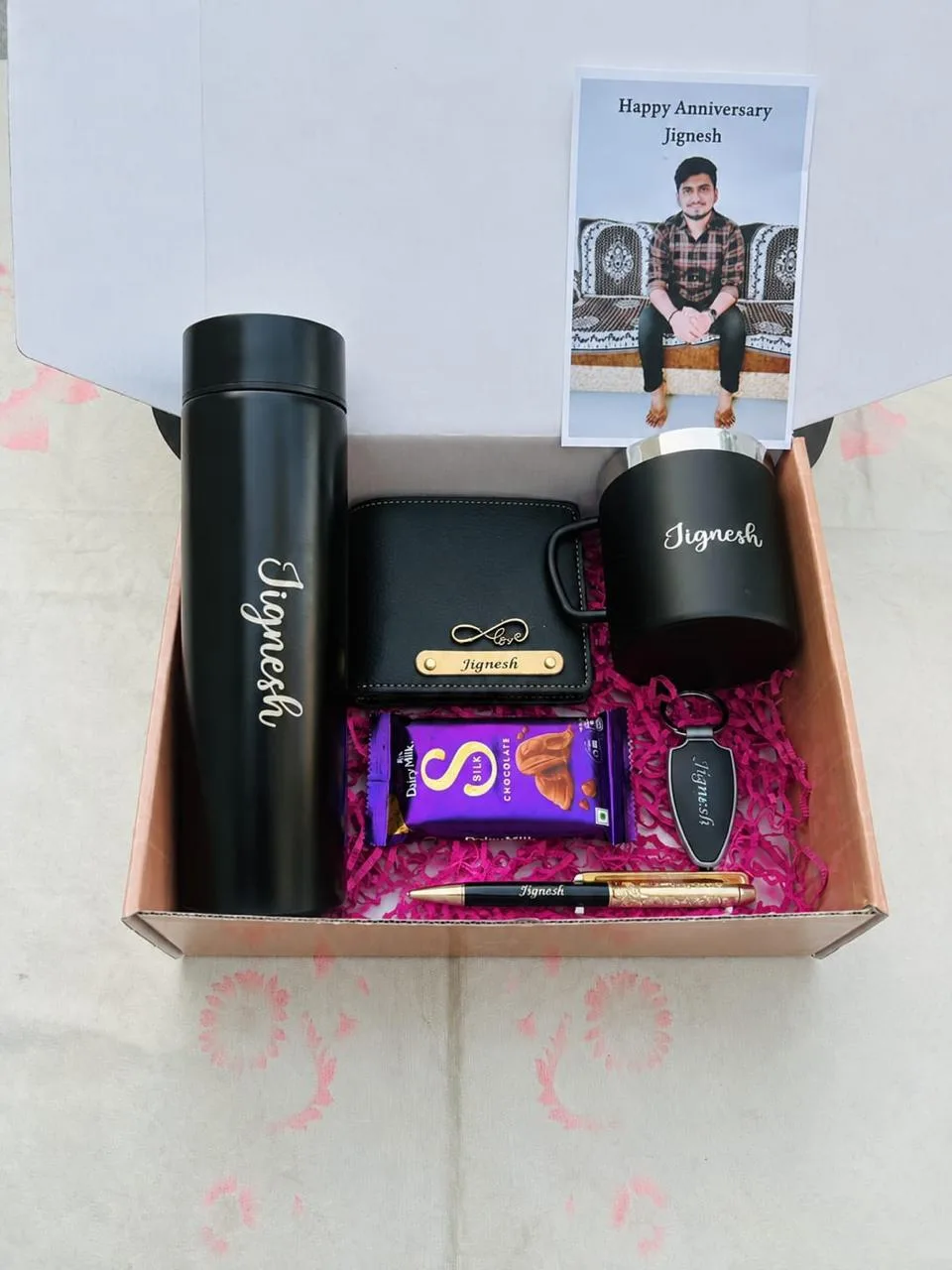Personalized Birthday Hamper for Husband Boyfriend | Youteek 1 Personalized birthday hamper box for men. Includes faux wallet, temperature bottle, gold flake pen, LED keychain, metal mug, Dairy Milk Silk and photo. Proper box packing. Making time 2-4 days. Delivery free. personalized birthday hamper for husband boyfriend